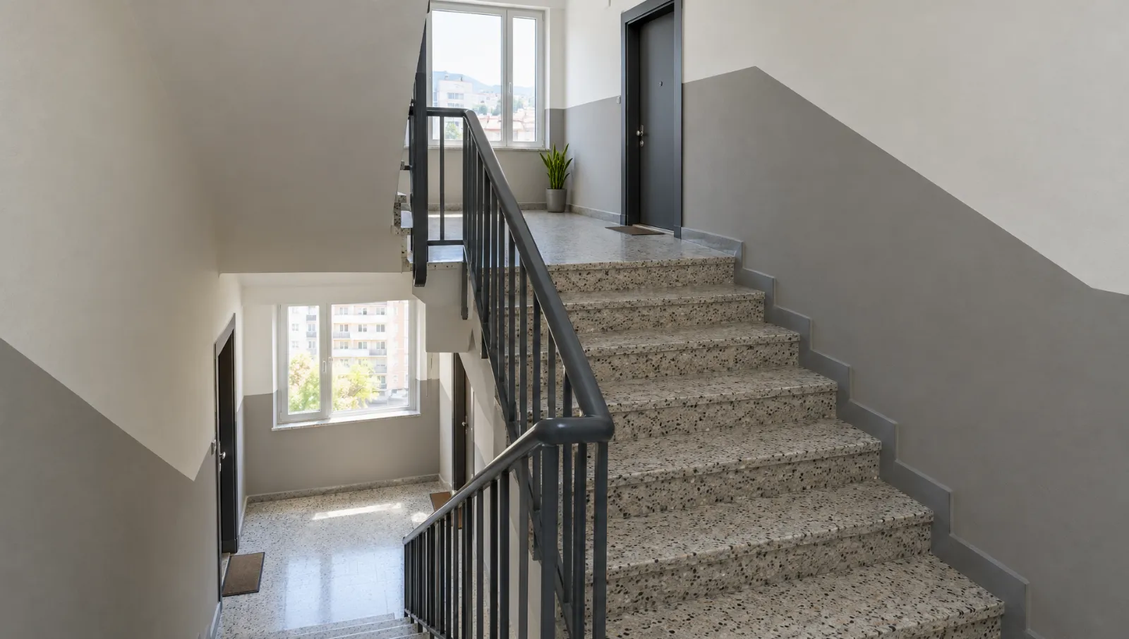 Alt kısmı koyu, üst kısmı açık renge boyanmış apartman merdiven boşluğu
